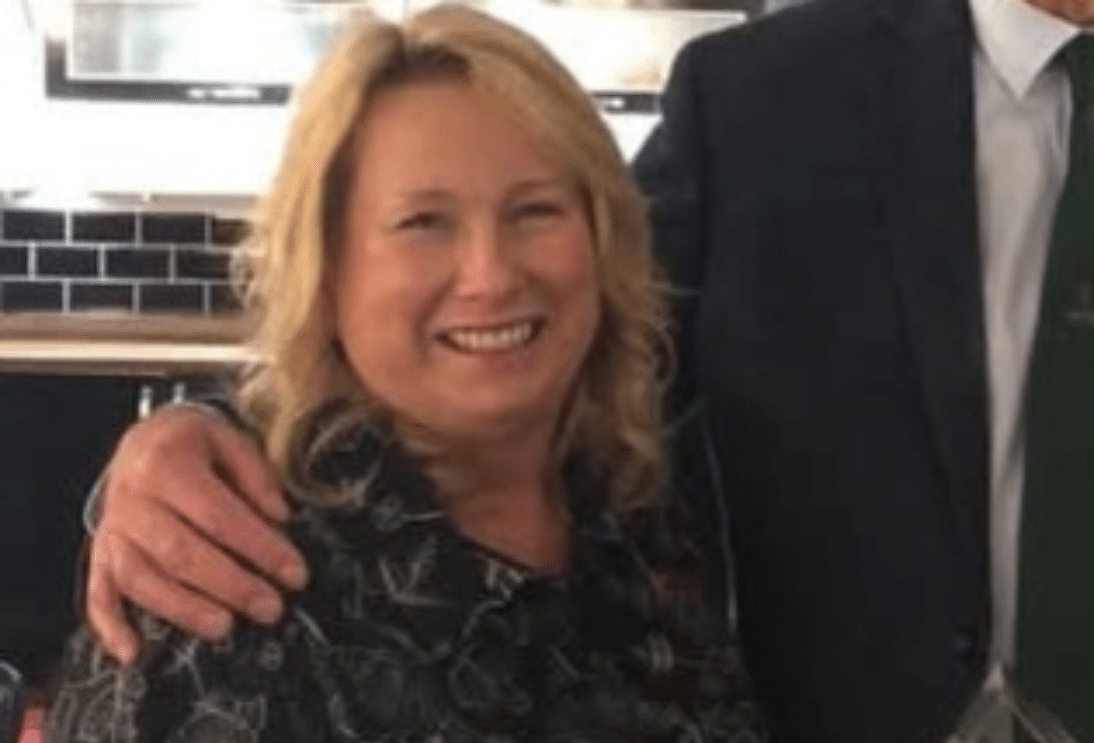 A photograph of a smiling, blonde older white woman.